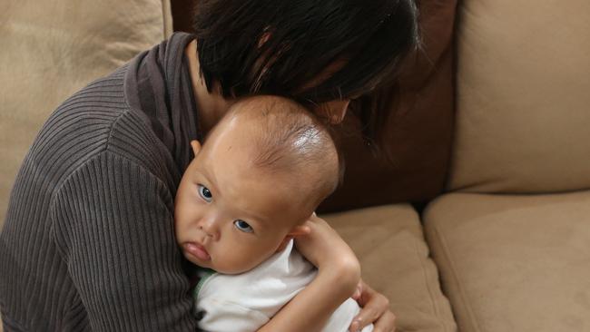 Mimi Lo with her 14-month-old baby girl Candice at their Robina home. Ms Lo was breastfeeding at Movie World and was told by a staff member to go into a bathroom. Picture: Glenn Hampson