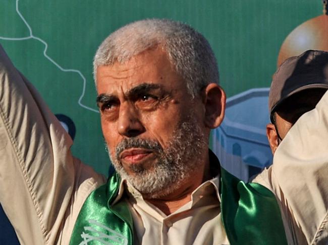 (FILES) Yahya Sinwar, leader of the Palestinian Hamas movement in the Gaza Strip, gestures on stage during a rally in Gaza City on May 24, 2021. Israel's foreign minister has called to "swiftly eliminate" Yahya Sinwar, who was appointed by Hamas on August 6, 2024 as the militant group's new political leader replacing Ismail Haniyeh who was killed in Tehran last week. (Photo by MAHMUD HAMS / AFP)