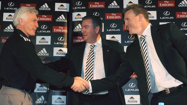 Mick Malthouse and Nathan Buckley shake hands as the succession plan is unveiled. Picture: AAP Image/Julian Smith