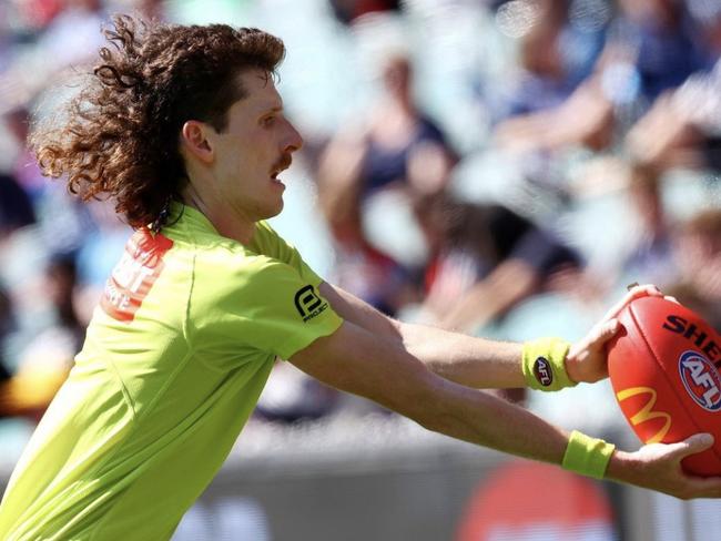 Boundary umpire Sean Moylan lets his locks flow. Picture: Michael Klein