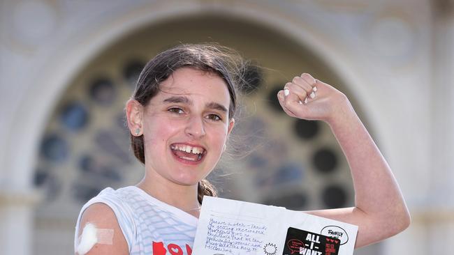 Freya, 12, from Northcote, celebrates after receiving a $1000 voucher for getting her first jab. Picture: David Caird