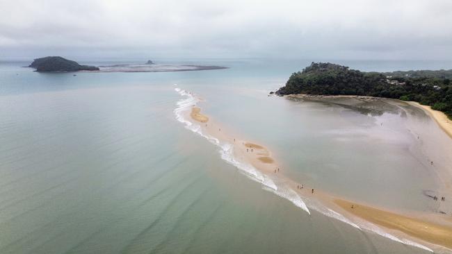 The lowest tide of the year has seen the sandbank off Buchan Point fully exposed out of the water, allowing people to walk halfway to Double Island, about 1 kilometre out from the beach. Picture: Brendan Radke