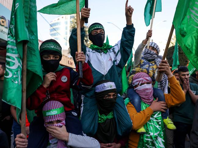 Young Palestinians wear masks and carry Hamas flags during a rally supporting the Gaza Strip. Picture: AFP