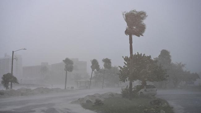 A car is seen parked as it rains heavily in Fort Myers, Florida, on October 9, as Hurricane Milton approaches. Picture: Chandan Khanna/AFP