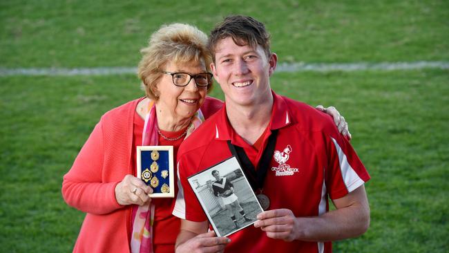 Crystal Brook Mail Medallist Campbell Combe with his Mail Medals, the framed medals of his late grandfather Peter Heinjus, and proud grandmother Jenni. Picture: Naomi Jellicoe/AAP