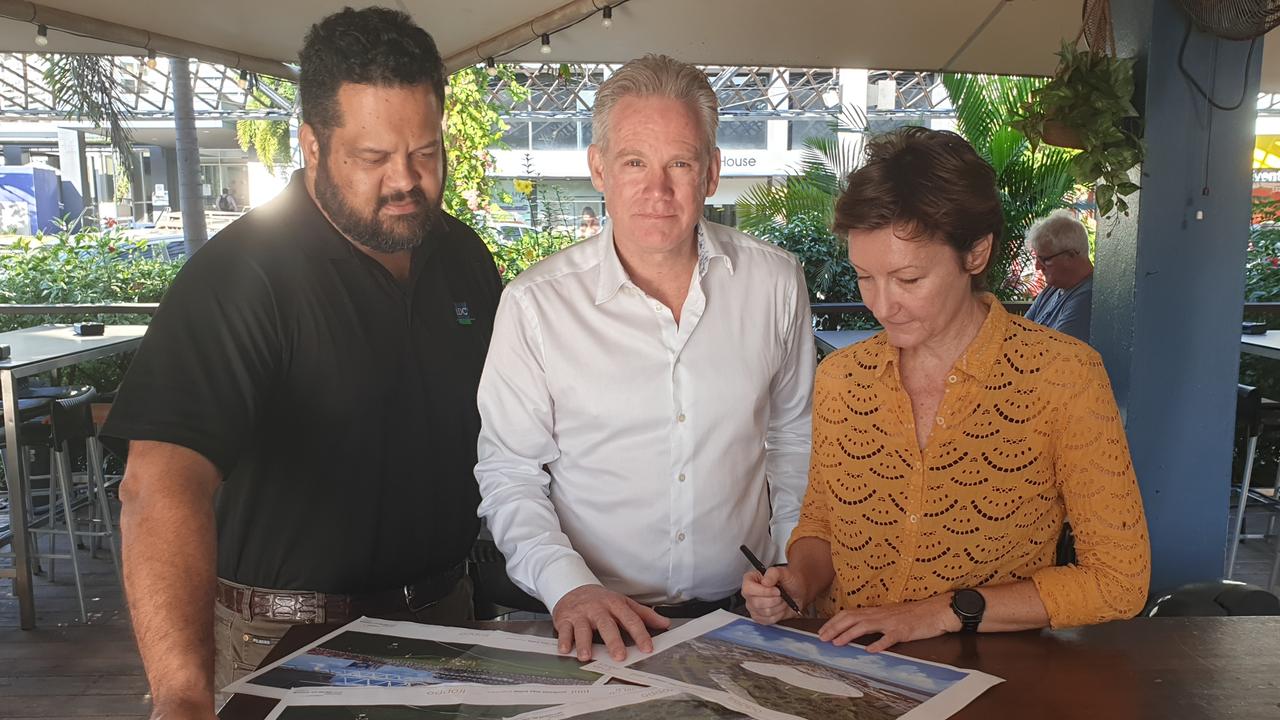 Larrakia Development Corporation chief executive Nigel Browne, AFLNT chairman Sean Bowden and Troppo Architects' Jo Best study the plans for Darwin's new sporting stadium. Picture: Grey Morris