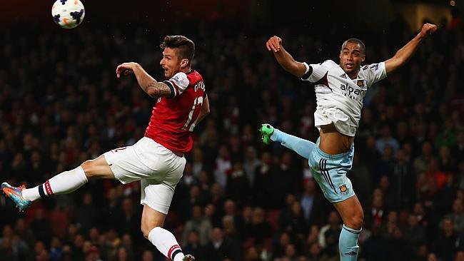 Olivier Giroud of Arsenal jumps with Winston Reid of West Ham United.