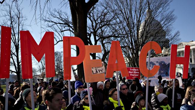 Demonstrators outside the US Capitol in Washington on December 18, the day the Democratic-controlled House of Representatives voted to impeach the President. Picture: Bloomberg