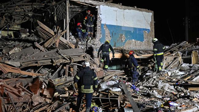 Rescuers look for survivors after Russia bombed a residential building in Kharkiv.