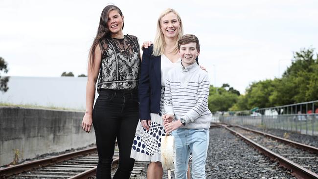 St Albi Bar and Eatery owner Lucy Baker, left with Glenorchy Mayor Kristie Johnston and her son, Harry, 12, on the northern suburbs rail corridor. Picture: LUKE BOWDEN