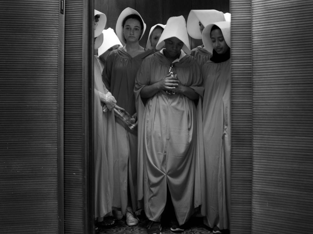 -- AFP PICTURES OF THE YEAR 2018 -- Women dressed as characters from the novel-turned-TV series "The Handmaid's Tale" stand in an elevator at the Hart Senate Office Building as Supreme Court nominee Brett Kavanaugh starts the first day of his confirmation hearing in front of the US Senate on Capitol Hill in Washington DC, on September 4, 2018. - President Donald Trump's newest Supreme Court nominee Brett Kavanaugh is expected to face punishing questioning from Democrats this week over his endorsement of presidential immunity and his opposition to abortion. Some two dozen witnesses are lined up to argue for and against confirming Kavanaugh, who could swing the nine-member high court decidedly in conservatives' favor for years to come. Democrats have mobilized heavily to prevent his approval. (Photo by Jim WATSON / AFP)