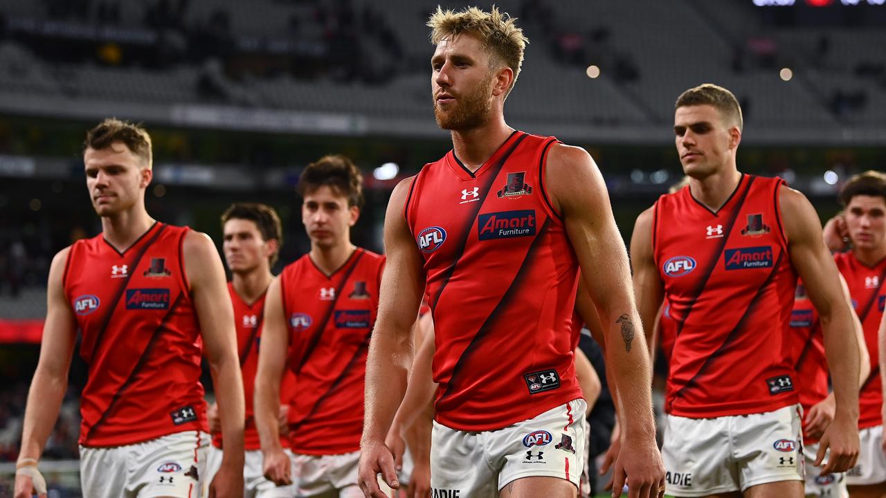 MELBOURNE, AUSTRALIA - APRIL 01: Dyson Heppell and his Bombers team mates look dejected after losing the round three AFL match between the Melbourne Demons and the Essendon Bombers at Melbourne Cricket Ground on April 01, 2022 in Melbourne, Australia. (Photo by Quinn Rooney/Getty Images)