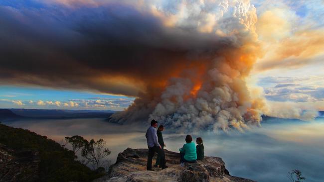 Like a volcanic plume, smoke from the burn-off rises through the clouds over the Blue Mountains. Picture: Graham Reibelt