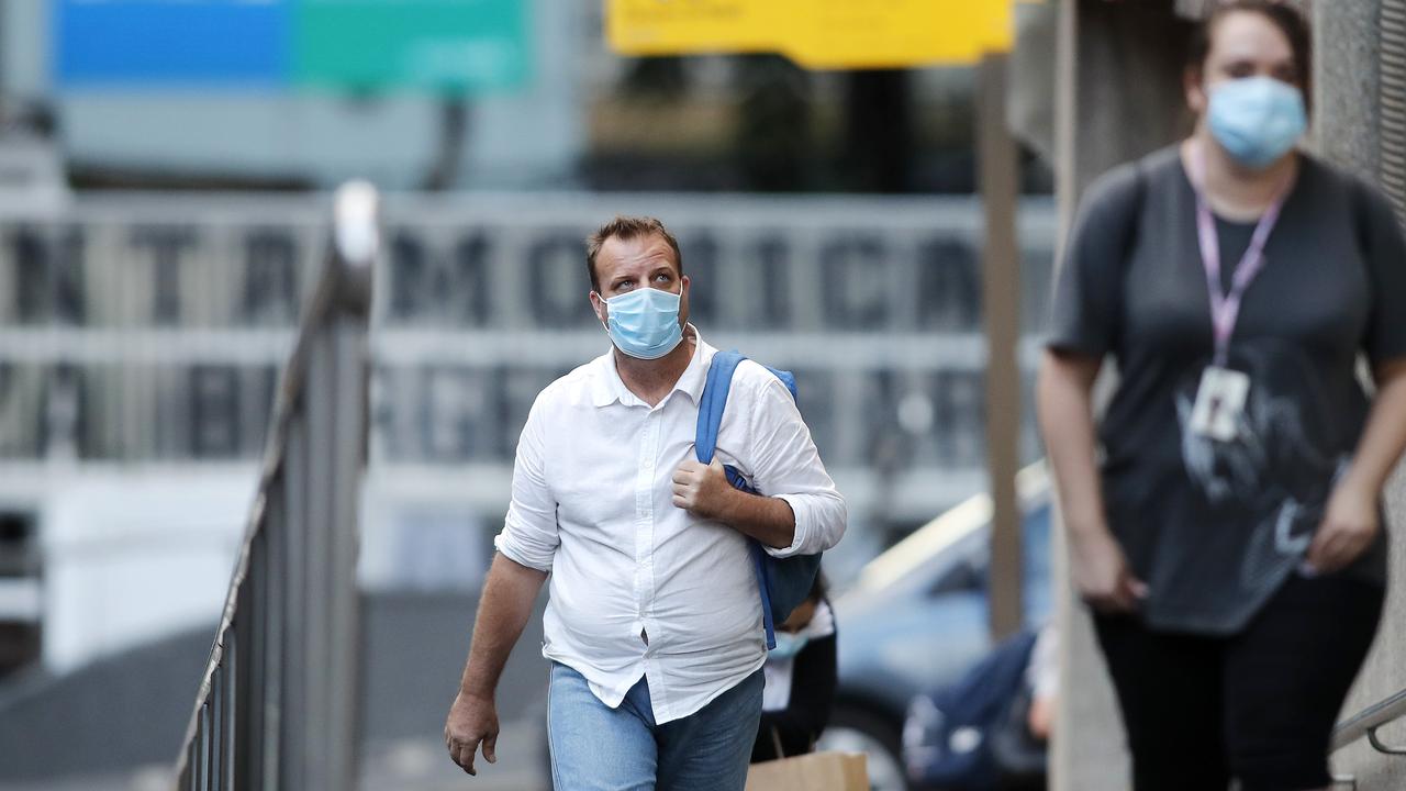 Pedestrians pictured at Central strain station after 5pm when mask wearing became mandatory. Picture: Josh Woning