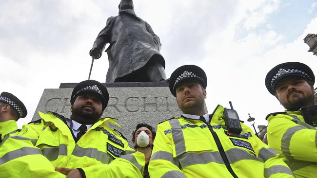 Police surround a Winston Churchill statue during a Black Lives Matter rally after it was defaced. Picture: AP