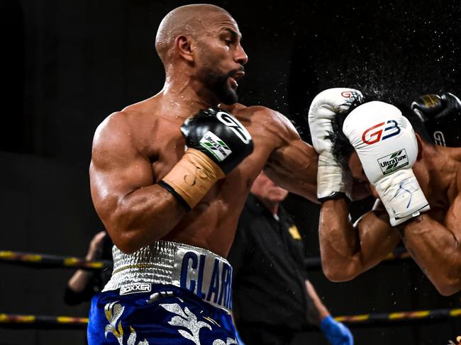 Clarke (left) in kickboxing action.