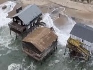 Stunning drone footage shows vulnerable oceanfront houses that dot the Outer Banks on the brink of collapsing into the sea.