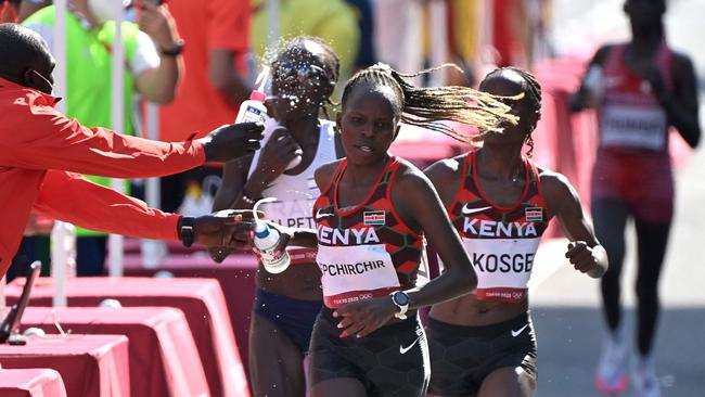 Kenya's Peres Jepchirchir and Brigid Kosgei at a drinks stop. Picture: AFP