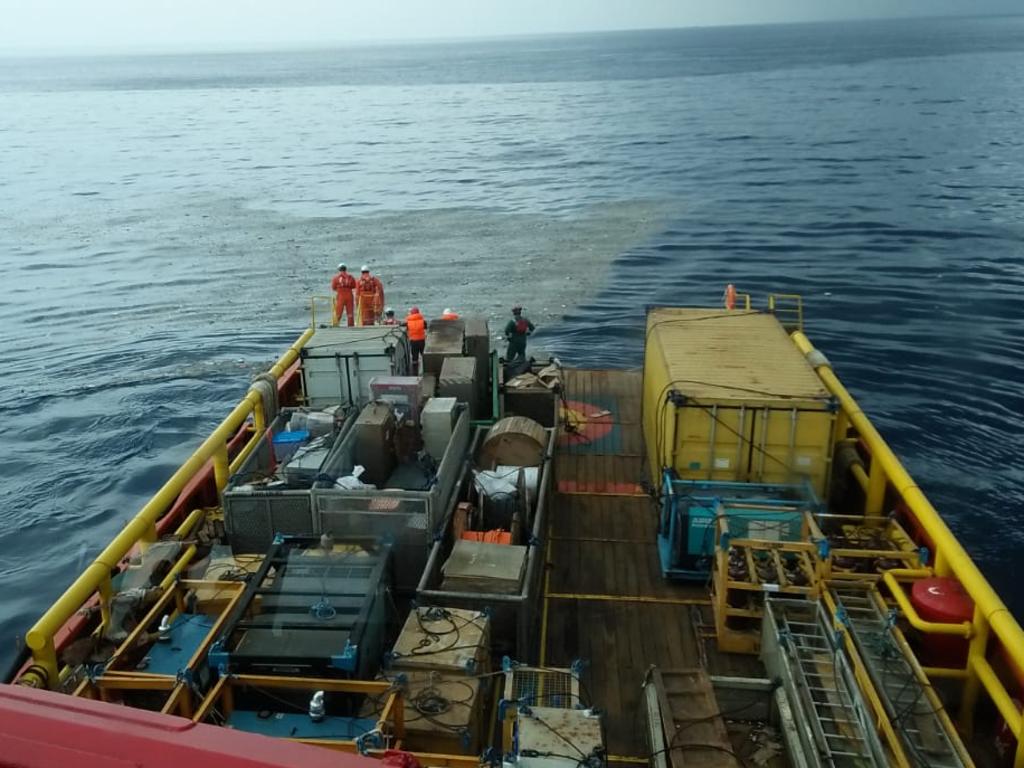 A commercial vessel surveys the oil slick and small floating debris at what is believed to be the crash site of the Boeing 737. Picture: Indonesia Rescue