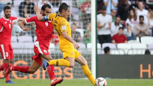 Australia's midfielder Mark Milligan (R) fights for the ball with Jordan's forward Baha Faisal during the 2019 AFC Asian Cup football game between Australia and Jordan at the Hazza Bin Zayed stadium in Al-Ain on January 6, 2019. (Photo by KARIM SAHIB / AFP)