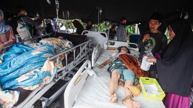 Wounded people in a tent displayed outside a hospital following an earthquake in Cianjur on November 21, 2022. Picture: AFP.