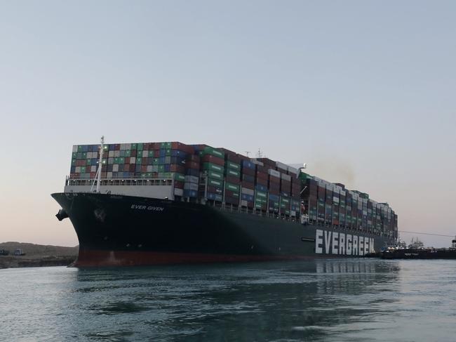 A handout picture released by the Suez Canal Authority on March 29, 2021 shows a view of the Panama-flagged MV 'Ever Given' (operated by Taiwan-based Evergreen Marine) container ship, a 400-metre- (1,300-foot-)long and 59-metre wide vessel, as it remains lodged sideways impeding traffic across Egypt's Suez Canal waterway. - Egypt's Suez Canal Authority said on March 29 the Ever Given container ship, which has been blocking the crucial waterway for nearly a week, has been turned in the "right direction". "The position of the ship has been reorientated 80 percent in the right direction," SCA chief Osama Rabie said in a statement. Over 300 ships are currently waiting to travel through the canal. (Photo by - / SUEZ CANAL AUTHORITY / AFP)