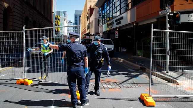 Police outside the Peppers Waymouth medi-hotel where barriers were being set up. Picture: Matt Turner