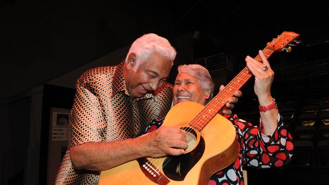 Aboriginal entertainer musician Jimmy Little shows Lowitja O'Donoghue how to strum the guitar at Tandanya. Picture: Mangan.