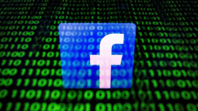 (FILES) In this file photo taken on April 26, 2018 in Paris shows the logo of social network Facebook displayed on a screen and reflected on a tablet. - Facebook announced it identified stealth misinformation campaigns from Russia and Iran and shut down hundreds of accounts as part of its battle against manipulation of its platform, prompting a fresh denial from Moscow on August 22, 2018. The social network said late Tuesday that it removed more than 650 pages, groups and accounts identified as "networks of accounts misleading people about what they were doing," according to chief executive Mark Zuckerberg. (Photo by Lionel BONAVENTURE / AFP)