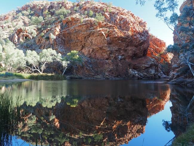 Reflection in the pond of Ellery Creek Big Hole in the McDonnell Ranges, Alice Springs, Australia, July 2015