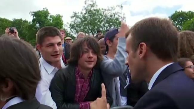 In this image made from video taken on Monday, June 18, 2018, French President Emmanuel Macron speaks with a teenage boy in Paris. A video of French President Emmanuel Macron is going viral Tuesday, June 19 on social media as he strongly admonished a teenager who spoke to him with familiarity. Macron said â€œcall me Mr President of the Republic or Sirâ€ to a schoolboy at a ceremony Monday for the 78th anniversary of Charles De Gaulle's historic appeal for armed resistance against Nazi tyranny. (TF1 via AP)