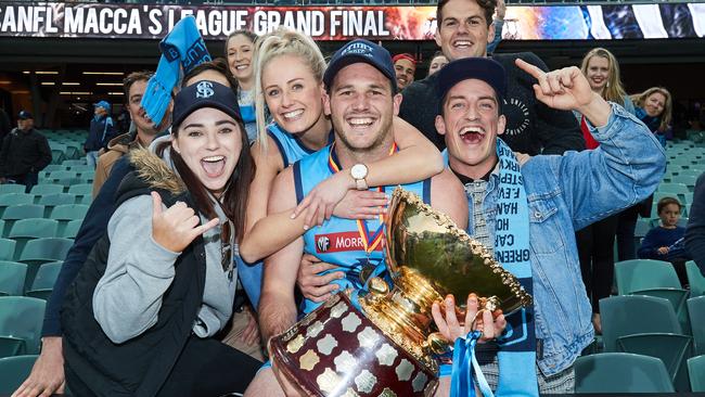 Aimee Thomson, Brooke Chaplin, Sturt captain Zane Kirkwood, Stewart Tremain and Jarrad Gatt pose for a picture after Sturt's win over Port Adelaide in the SANFL Grand Final at Adelaide Oval in 2017. Picture: AAP Image/MATT LOXTON