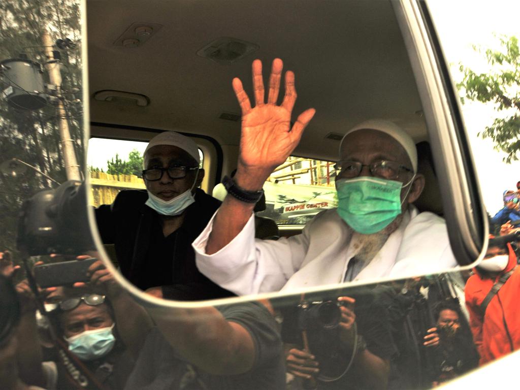 Abu Bakar Bashir, 82, once synonymous with militant Islam in the world's biggest Muslim majority nation and linked to the 2002 Bali nightclub bombings, waves as he arrives back in his hometown of Sukoharjo on January 8, after his release from prison. Picture: AFP