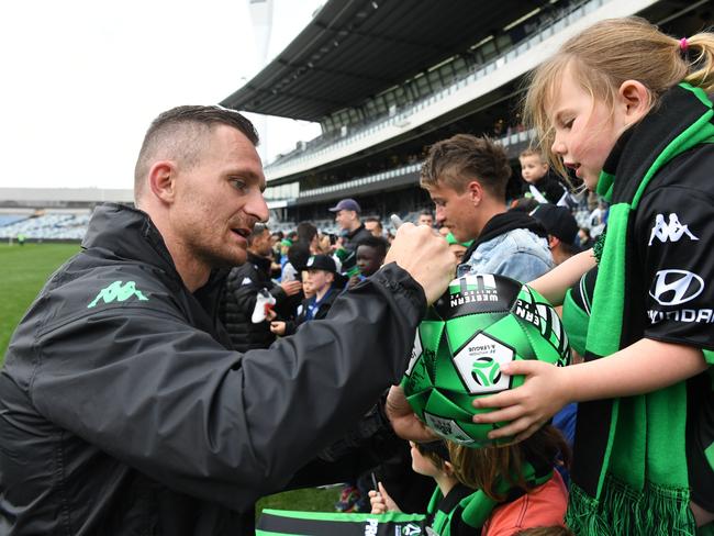 Besart Berisha (left) of Western United signs an autograph for a fan following the A-League friendly match between Western United and the Western Sydney Wanderers at GMHBA stadium, Geelong, Saturday, October 5, 2019. (AAP Image/James Ross) NO ARCHIVING, EDITORIAL USE ONLY