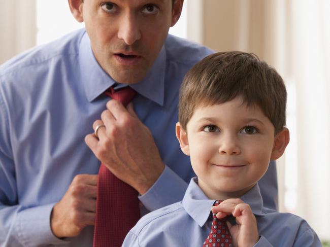 Father and son fixing ties together.