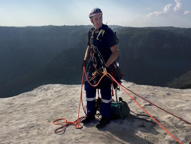 Paramedic Damon Anderson prepares to abseil down the cliff to assist Isaac Ebeling. Picture: NSW Ambulance Media