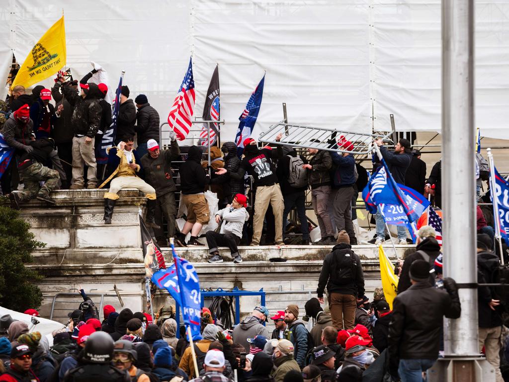 A group of pro-Trump protesters climb the walls of the Capitol building on January 6. Picture: Jon Cherry/Getty Images/AFP