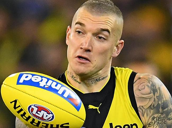 MELBOURNE, AUSTRALIA - JUNE 07: Dustin Martin of the Tigers handballs whilst being tackled by Jake Kolodjashnij of the Cats during the round 12 AFL match between the Richmond Tigers and the Geelong Cats at Melbourne Cricket Ground on June 07, 2019 in Melbourne, Australia. (Photo by Quinn Rooney/Getty Images)