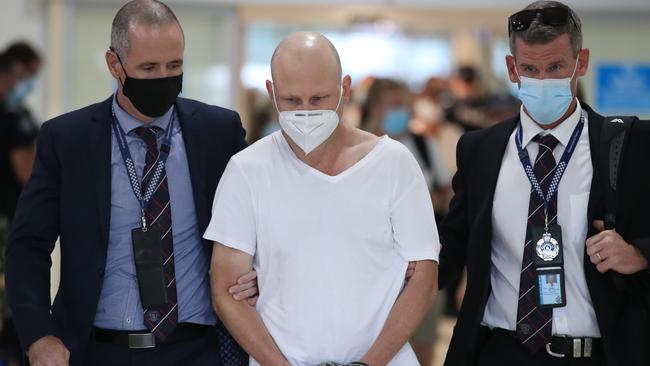 Ex-snooker champion Michael Tillman with police at the Gold Coast Airport. Picture Glenn Hampson