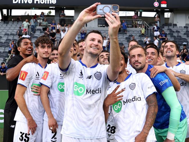 SYDNEY, AUSTRALIA - JANUARY 26: Tommy Smith of Auckland FC takes a 'selfie' with his team mates at full-time during the round 16 A-League Men match between Western Sydney Wanderers and Auckland FC at CommBank Stadium, on January 26, 2025, in Sydney, Australia. (Photo by Brendon Thorne/Getty Images)