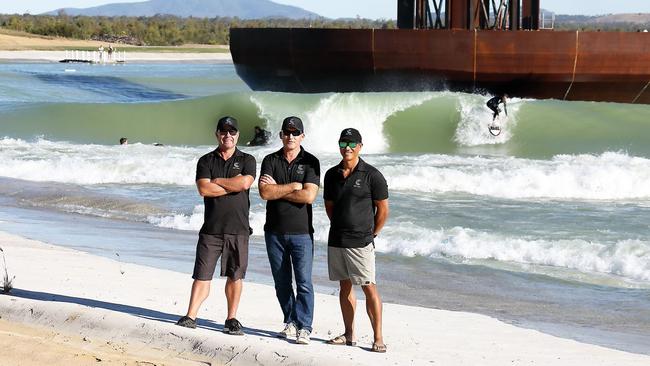 General Manager Global Operations and International Media Director Wayne Dart (left), founder and CEO Aaron Trevis and Director Reuben Buchanan pose for a photo while the barrels roll in at Surf Lakes.