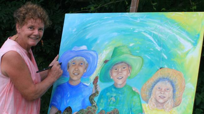 Susan Gee with a painting of her three children. Picture: Contributed.