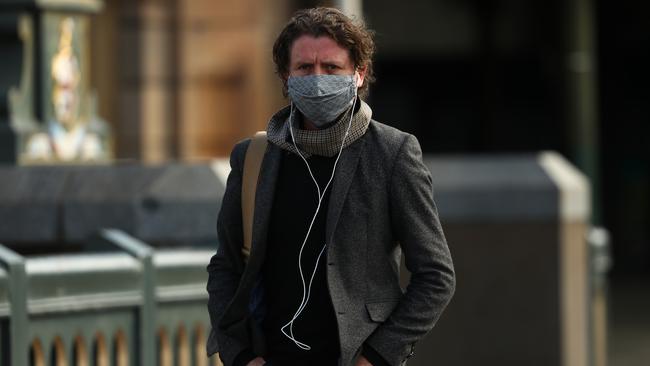 A man ‘masks up’ on Princes Bridge, Melbourne, on Thursday. Picture: Getty Images