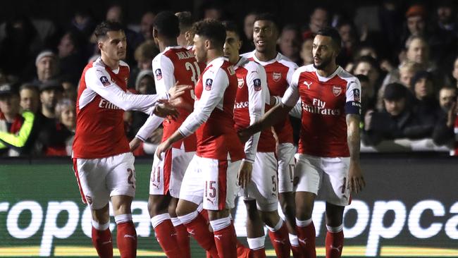 Arsenal's players celebrate Theo Walcott's goal.