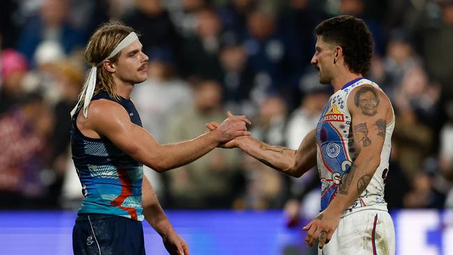Smith and former Bulldogs teammate Tom Liberatore shake hands after bashing each other throughout last week’s grudge match.