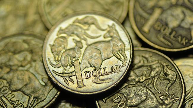 Close-up of used Australian one dollar coin photographerd in Melbourne, Wednesday, June 13, 2012. Reserve Bank of Australia governor Glenn Stevens today said there are big benefits to Australian's as consumers from the high Aiustralian dollar (AUD). (AAP Image/Julian Smith) NO ARCHIVING