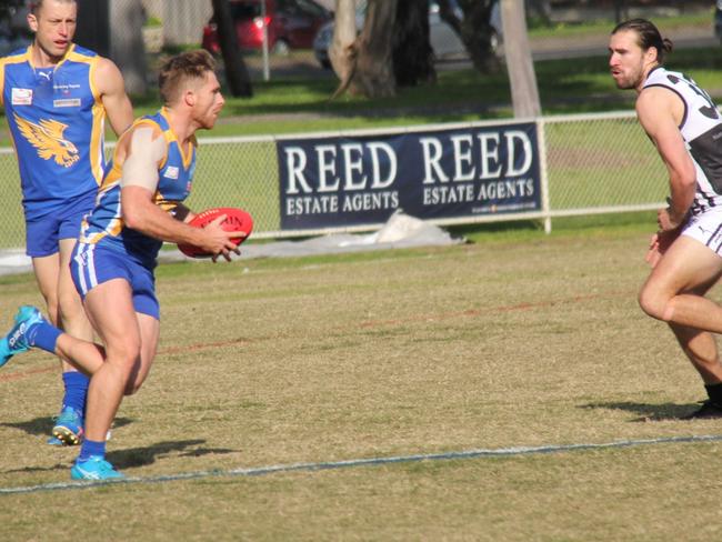 Brad Riddle looks to evade a would-be tackler. Picture: Gavin Dore