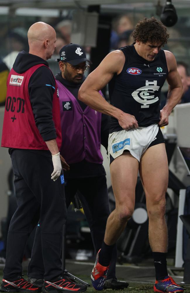 Charlie Curnow of the Blues leaves the field with a trainer on Saturday night. Picture: Daniel Pockett/Getty Images.