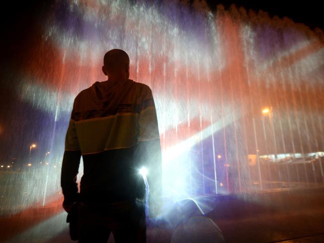 TOPSHOT - A man stands in front of a fountain illuminated with the colours of the United Kingdom flag on May 23, 2017, in Zagreb, during a tribute to victims of an attacks claimed by Islamic State which killed at least 22 people and left more than 60 injured in Manchester the day before. Twenty two people have been killed and dozens injured in Britain's deadliest terror attack in over a decade after a suspected suicide bomber targeted fans leaving a concert of US singer Ariana Grande in Manchester. British police on May 23 named the suspected attacker behind the Manchester concert bombing as Salman Abedi, but declined to give any further details. / AFP PHOTO / STRINGER