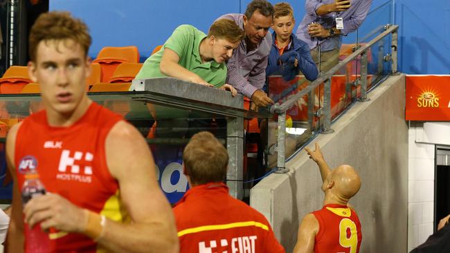 Gary Ablett confronts a fan abusing his Suns teammates. Picture: Adam Head